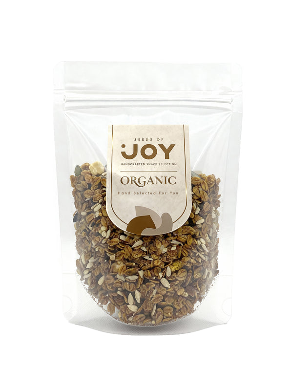 Seeds of Joy Organic Dark Hazelnut Granola front packaging. Hand selected for you. Delicious! Top your morning yogurt with it.