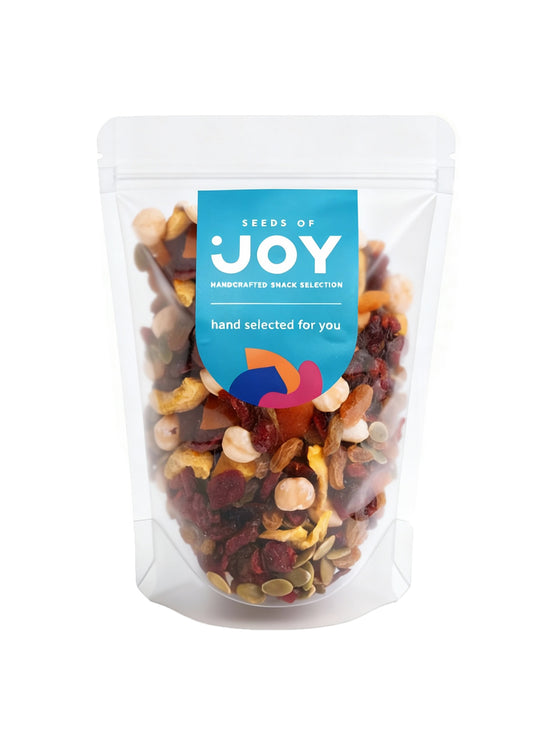 Seeds of Joy Premium Mix front packaging. Green Raisin, Dried Cranberries, Preserved Guava, Apricot with Honey, Baked Pecans, Natural Cashews, Natural Almonds, Baked Brazil Nuts, Dried Tomato. Hand selected for you!