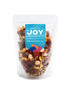 Seeds of Joy Premium Mix front packaging. Green Raisin, Dried Cranberries, Preserved Guava, Apricot with Honey, Baked Pecans, Natural Cashews, Natural Almonds, Baked Brazil Nuts, Dried Tomato. Hand selected for you!