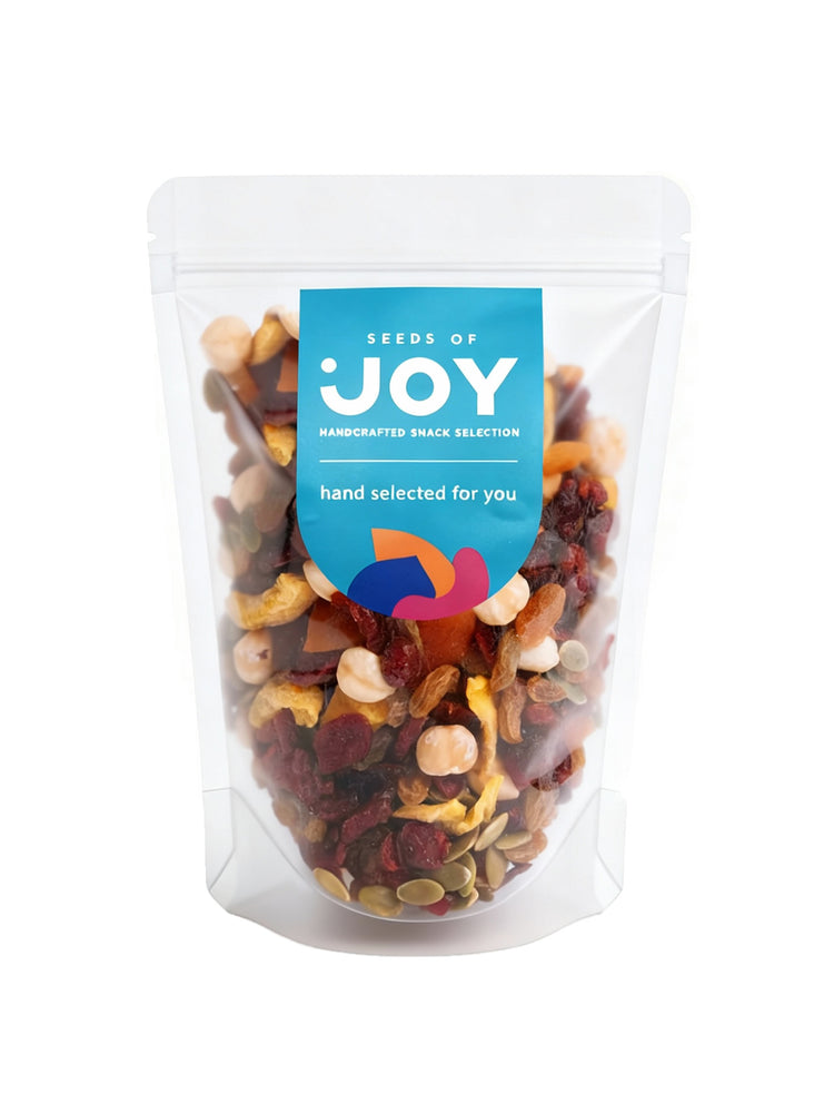 Seeds of Joy Premium Mix front packaging. Green Raisin, Dried Cranberries, Preserved Guava, Apricot with Honey, Baked Pecans, Natural Cashews, Natural Almonds, Baked Brazil Nuts, Dried Tomato. Hand selected for you!